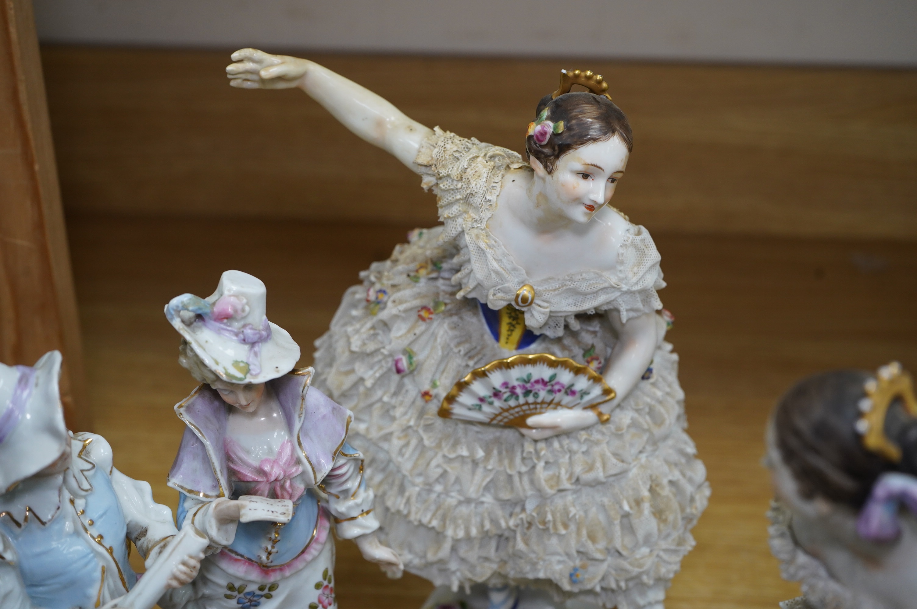A collection of Continental porcelain ceramic figurines, including a pair of lace examples, dancing ladies and an easel mirror, largest 29cm high. Condition - mostly poor
